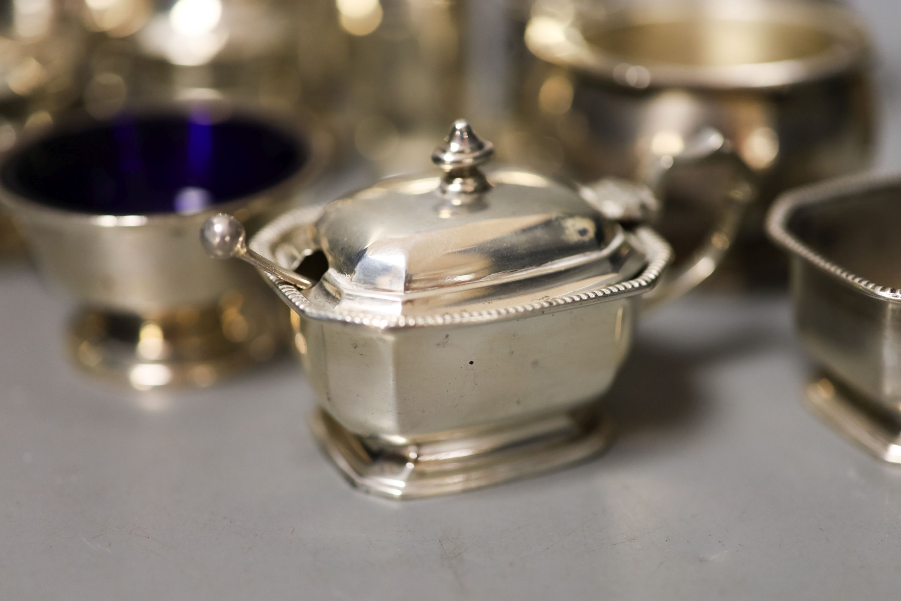 Twelve assorted 20th century silver condiments including an Art Deco three piece set, Birmingham, 1939.